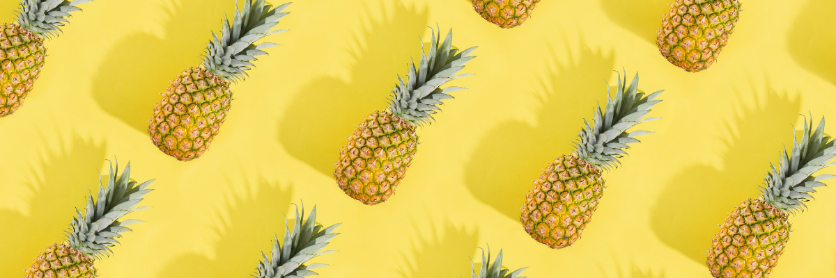 A header image featuring a bright yellow background and a repeating pattern of whole pineapples with a slight drop shadow.